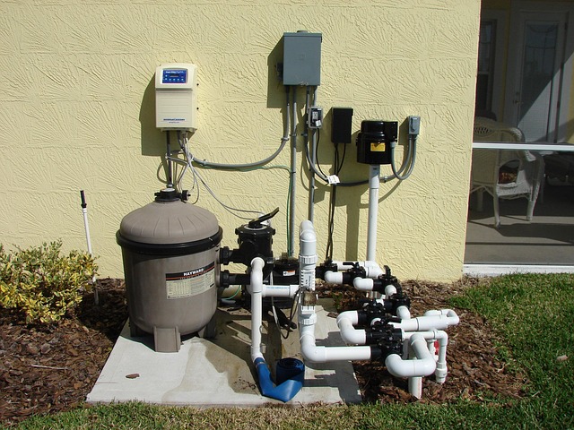 A standard single speed pool pump and motor sitting on a concrete equipment pad