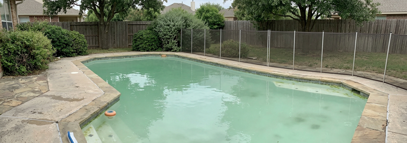 A swimming pool with cloudy, milky white water where the bottom is not visible